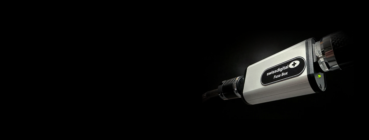 A Swiss Digital Fuse Box in a pitch black background.