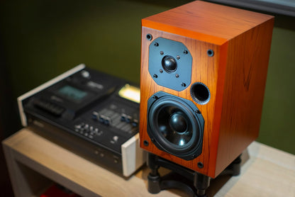 Wooden speaker on a table with a blurred background